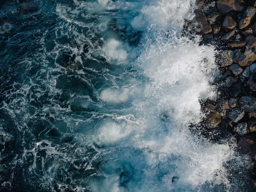 Preview: Rocky beach in the south of Tenerife with waves crashing on the beach of volcanic stones