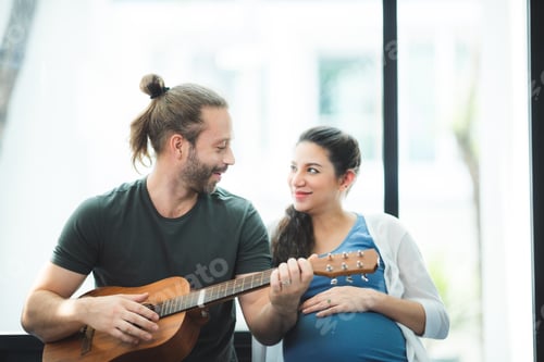 Preview: Happy pregnant couple waiting for baby at home, Pregnant couple of husband and wife