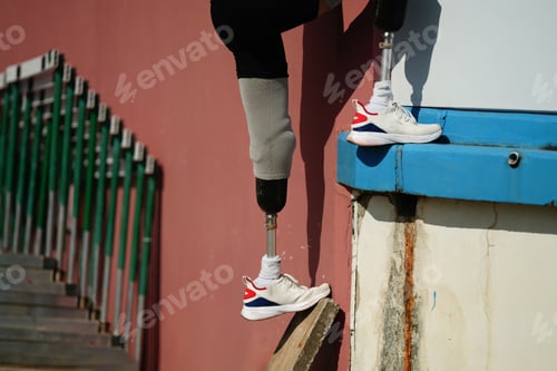 Preview: Asian para-athletes with prosthetic blades sprint on a running track at stadium.