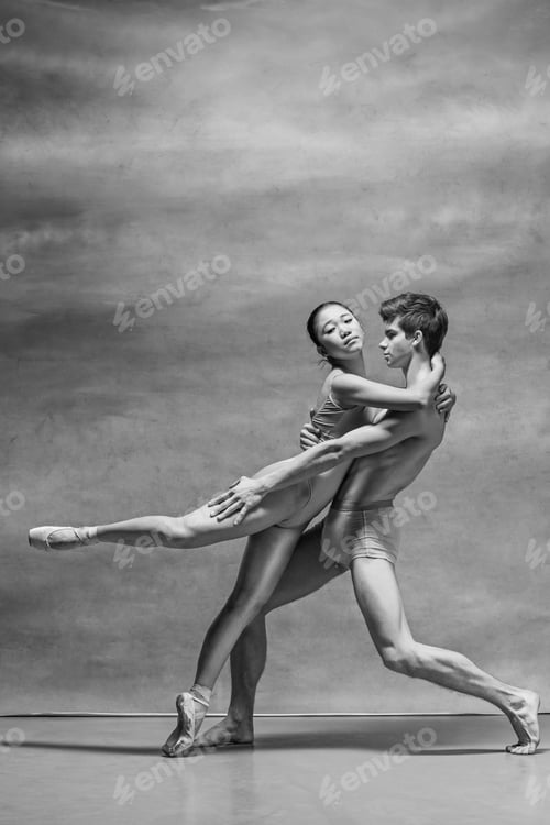 Preview: Couple of ballet dancers posing over gray background