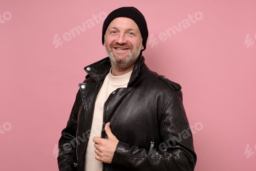 Preview: Confident handsome mature man in leather jacket smiling looking at camera