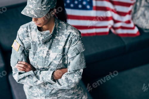 Preview: african american female soldier with crossed arms in military uniform with usa flag emblem