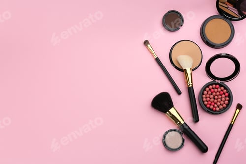 Preview: Different makeup brushes and cosmetic products on pink background, flat lay. Space for text