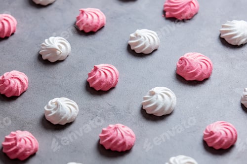 Preview: pink and white meringues on a gray background