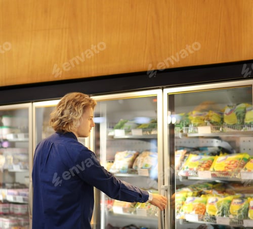 Preview: Man Choosing Frozen Food From A Supermarket Freezer