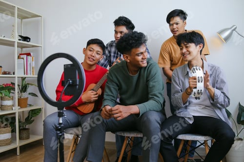 Preview: Group Of Diverse Friends Playing Music Together In Front Of Ring Light During Online Live Streaming
