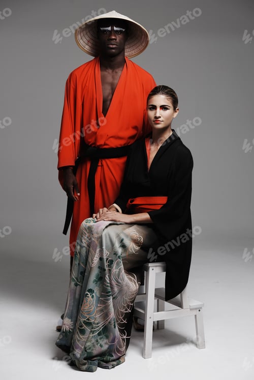 Preview: Yin and yang. Studio fashion shot of a man and woman wearing oriental-style clothing.
