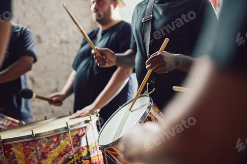Preview: Can you feel the beat. Closeup shot of a musical performer playing drums with his band.