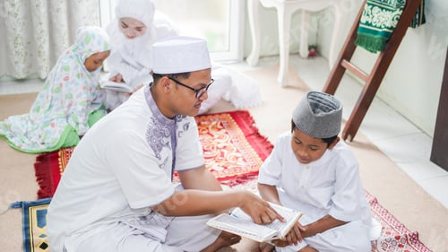 Preview: Asian Muslim families read the quran after prayers