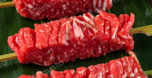 Preview: Beef Shish Kebab, stripes sliced meat on wooden board. Homemade cooking shish kebab beef or restaura