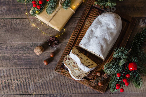 Preview: Traditional Christmas festive pastry dessert with festive decoration. Christmas stollen