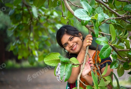 Preview: Beautiful girl between nature full of branches of tree.