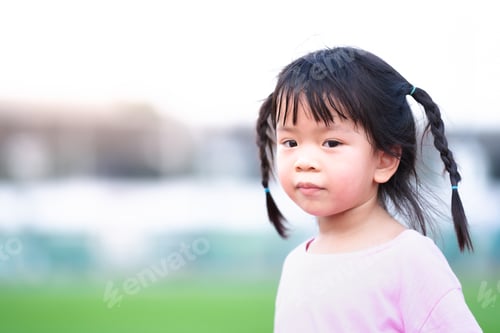 Preview: Portrait images. Cute Asian girl face is turning to the camera and smiling softly.
