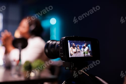 Preview: Couple recording online show using camera