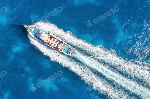 Preview: Aerial view of beautiful floating yacht in blue sea on sunny day in summer. Sardinia island, Italy