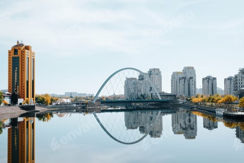 Preview: bridge with reflection in the Ishim river in the capital , modern city architecture