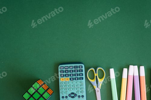 Preview: Colorful school supplies on a green background
