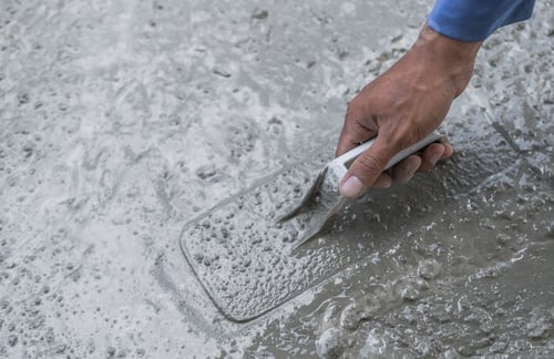 Preview: Hand plasterer plastering cement wall background, hand worker brush rough concrete floor