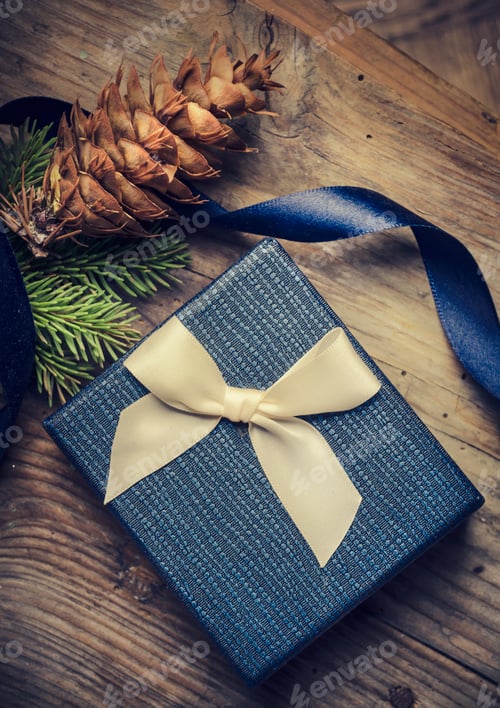 Preview: Gift Box with Pine Cone on Wood Surface