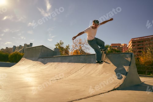 Preview: Young skateboarder flies with his board on the ramp of a skate park