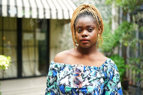 Preview: Woman with Braided Hair Outdoors in Stylish Top