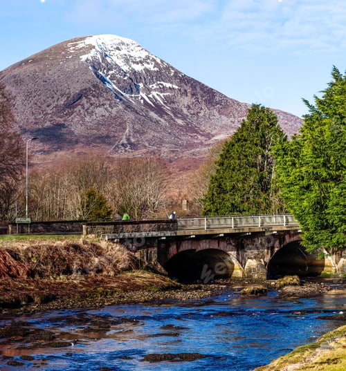 Preview: Scenic view of a majestic mountain rising in the distance near a bridge in Isle of Skye, Scotland,UK