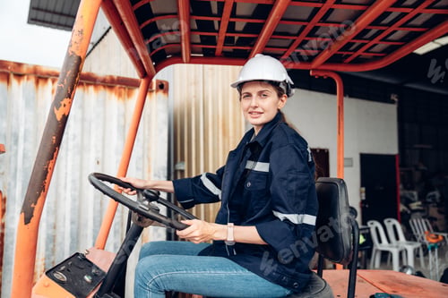 Preview: Portrait of woman forklift driver in factory,.