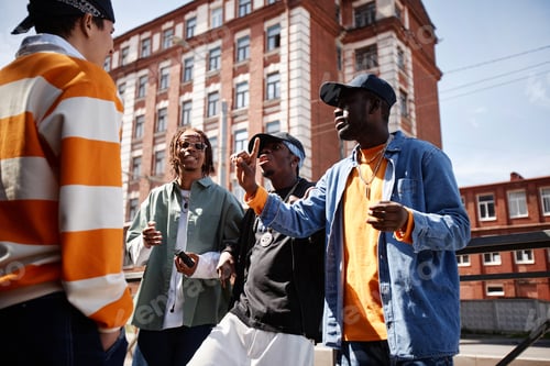 Preview: Group of young intercultural men in stylish attire performing hip hop outdoors