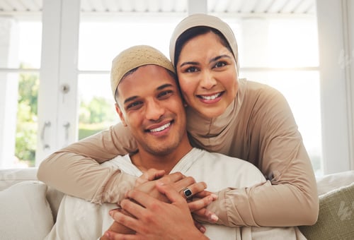 Preview: Portrait, Islam and happy couple hug on couch with smile, culture and love in home in Turkey. Face