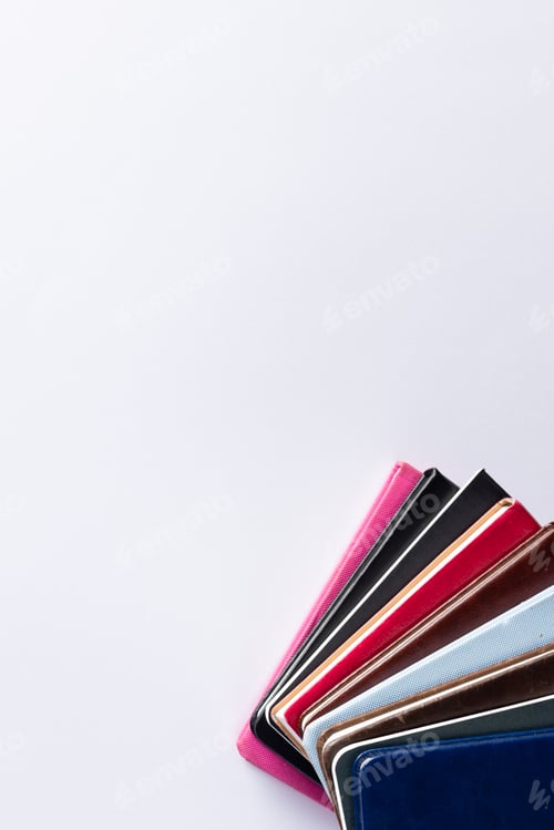 Preview: Close up of stack of books and notebooks with copy space on white background