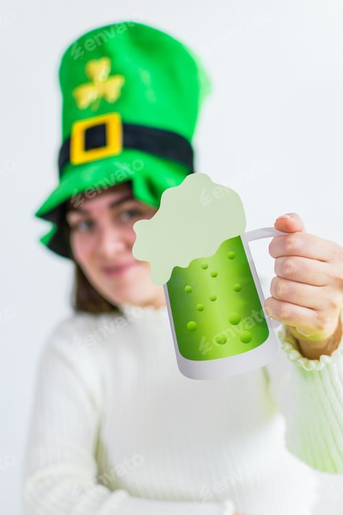 Preview: Smiling female in a green hat holding a paper glass of beer - Saint Patrick's Day Holiday
