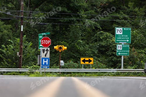Preview: Low-angle shot of traffic signs and symbols on the side of a road