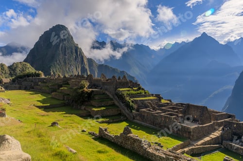 Preview: A stunning view of Machu Picchu with lush green terraces and ancient stone structures.
