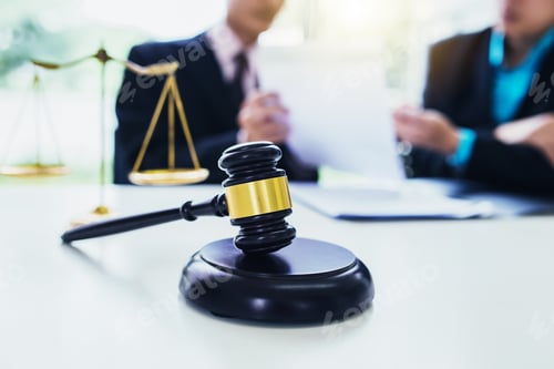 Preview: Lawyers discuss together at work.