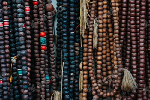 Preview: Closeup of Tibetan Buddhist prayer beads in Nepal in dark colors