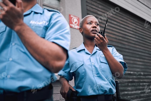 Preview: Security, walkie talkie and a black woman police officer in the city during her patrol for safety o