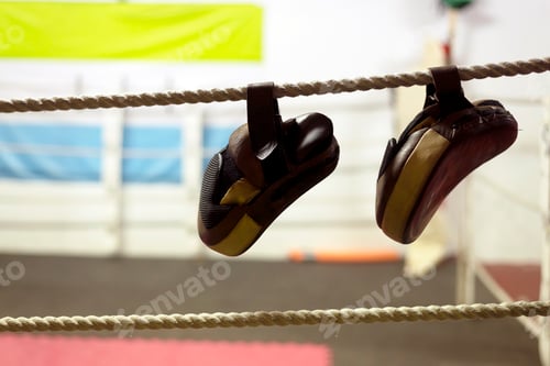 Preview: Black boxing and kicking practice pads hung up at boxing ring