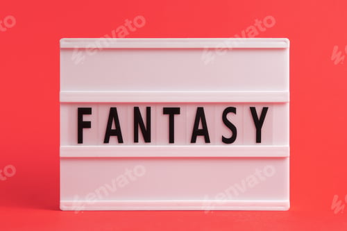 Preview: The word fantasy on lightbox isolated red background. Literary Genres