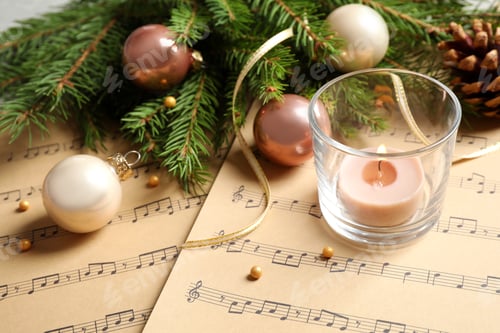 Preview: Composition with Christmas decorations on music sheets, closeup