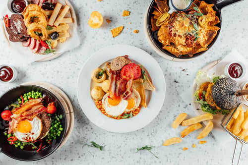 Preview: Overhead shot of a variety of fast food, meat, and snacks