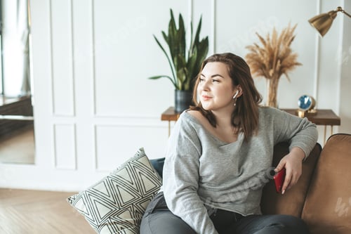 Preview: Woman relaxing indoors while listening to music
