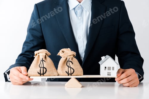 Preview: cropped view of businessman near scales with money bags and carton house isolated on white