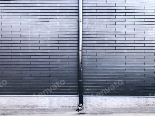 Preview: Metal Drainpipe on Grey Brick Wall Background