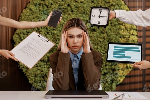 Preview: Stressed businesswoman overwhelmed with tasks in modern office