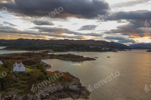 Preview: Stunning rocky beach and highlands at Elgol on the Isle of Skye under a cloudy sunset sky, Scotland