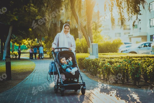 Preview: Arabic mom and her little toddler playing outdoors
