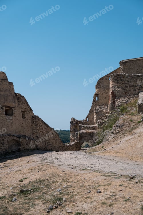 Preview: an old stone city is sitting on a hill on the beach