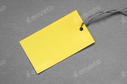 Preview: Yellow paper tag on gray background, copy space