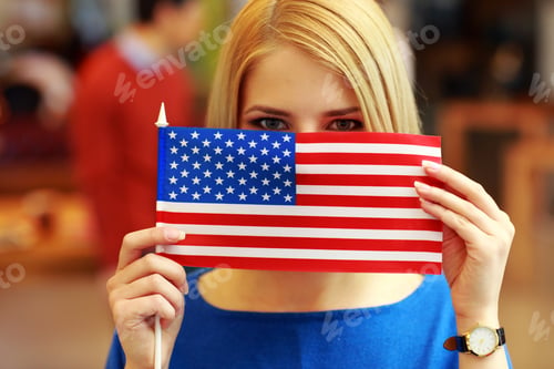 Preview: Portrait Of A Student Peeking Behind Flag Of Usa