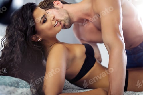Preview: Attractive young sexy woman with her partner in bedroom